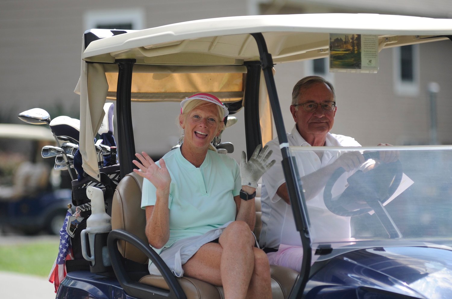 The joy of golf. A couple heads out to the back nine at the start of the fund-raising golf tourney.